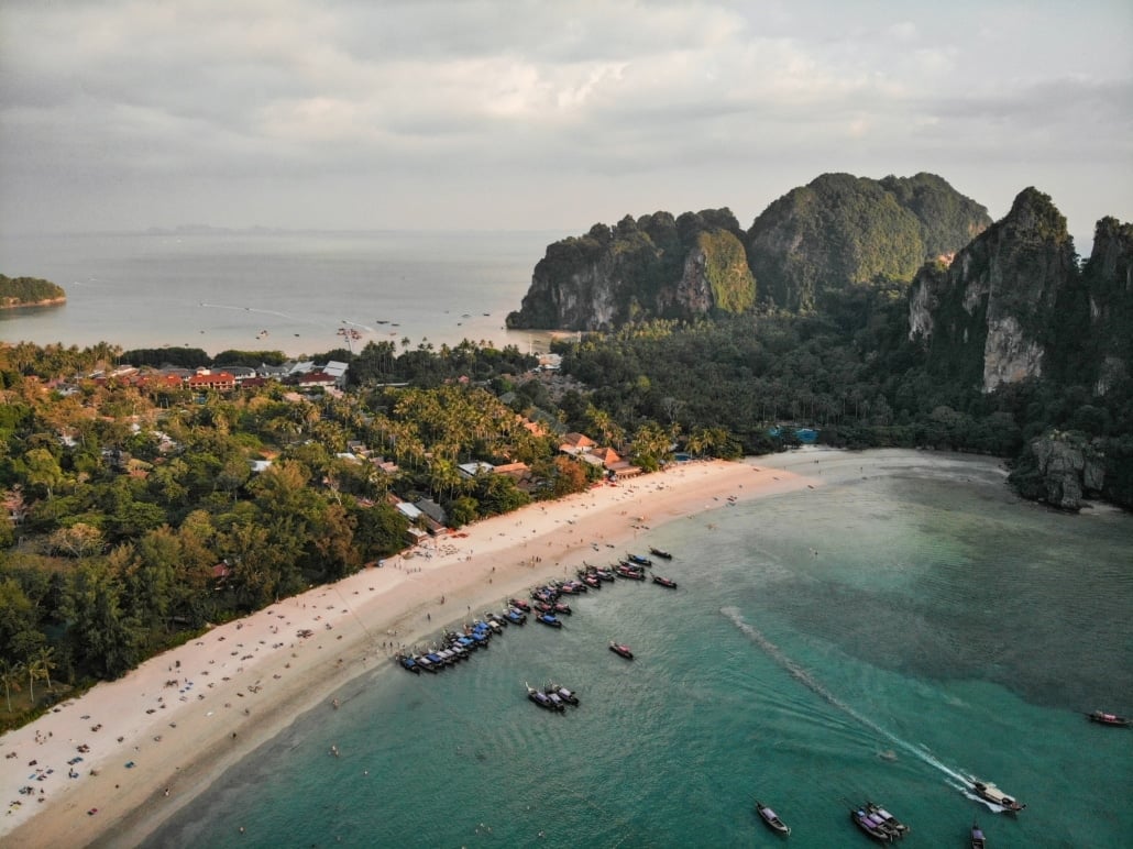 Arriving in Khao Sok: Airports, Transfers and Timing 6 Aerial view of a Krabi beach with long-tail boats and limestone cliffs